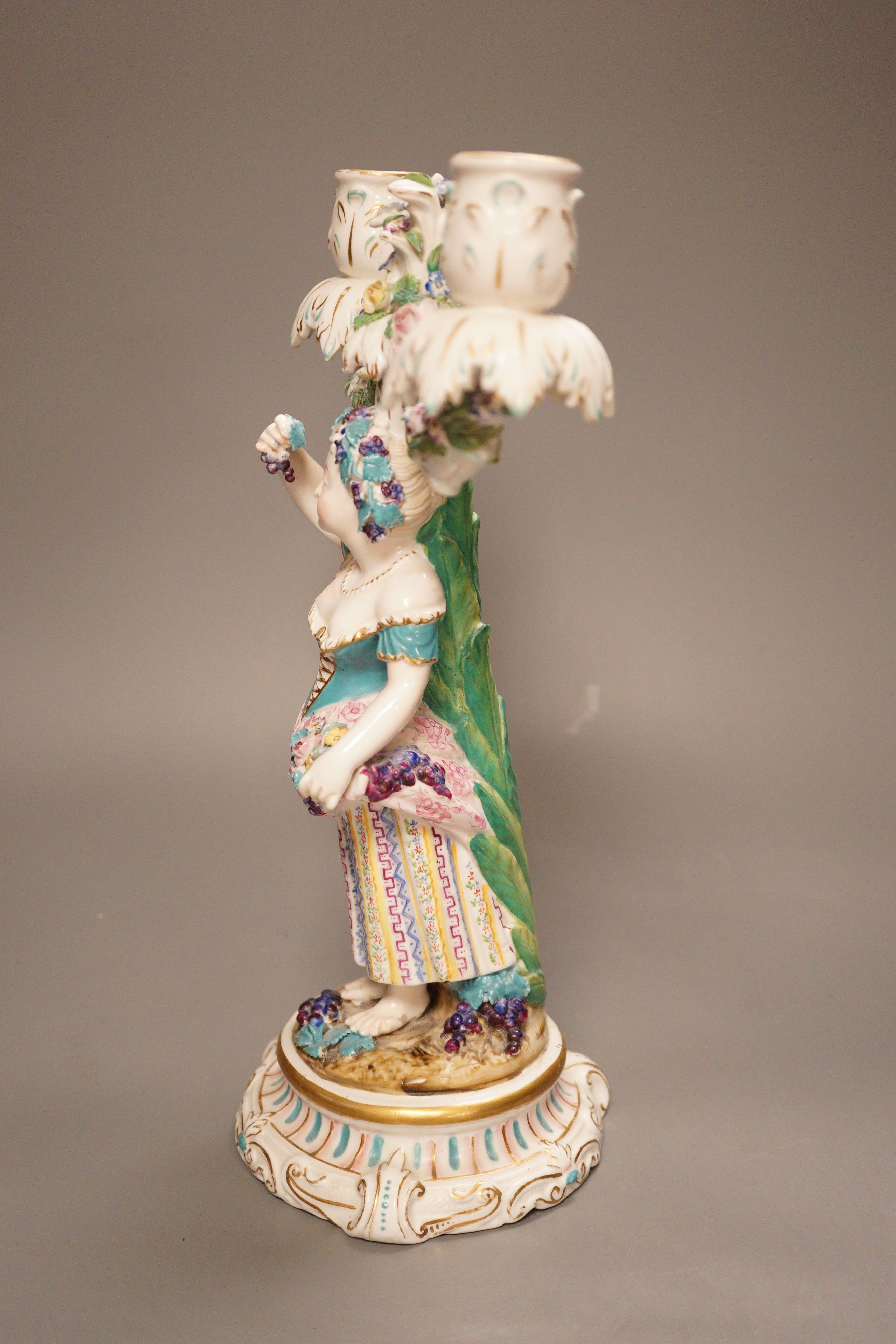 A 19th century English porcelain figural twin branch candelabrum, probably Minton, c.1835, 34cm